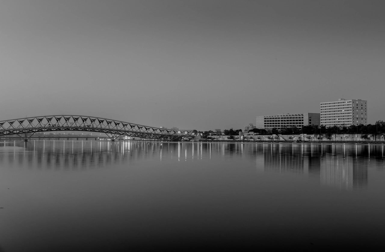 "A bridge over Ahmedabad’s Sabarmati River under a hazy sky, the city where TAFCO began solving indoor air problems."